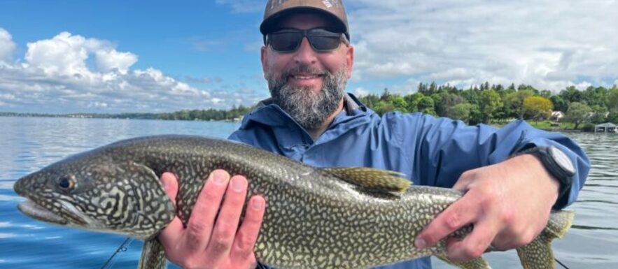 finger lakes fishing in new york man holding fish